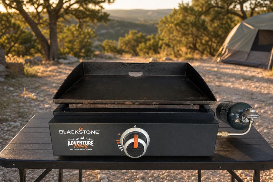 Flat top propane griddle set up on a camp table at a Hill Country campsite